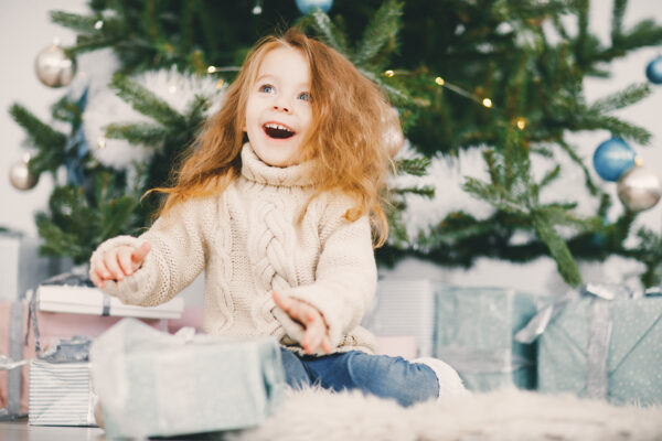 beautiful blonde girl opening gifts 600x400